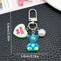 Mini resin iridescent bear and pearl heart keychain accessory for backpacks and bags - Transparent Green (ER1934)