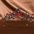 Detailed shot of a vintage gold bridal crown with red gemstones and black crystals - Antique Red