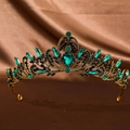 Detailed close-up of emerald green pear-shaped gemstones on a vintage gold tiara - Antique Green