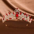 Detailed close-up of a gold wedding crown featuring teardrop red gemstones and rhinestones - Gold Red