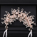 Macro detail of rose gold bridal hair vine with rhinestone flowers and metallic leaves - Hair Band / Gold