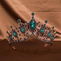 Macro shot of vintage Baroque crown with emerald rhinestones and black crystals - Dark Green