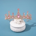 Elegant gold bridal tiara with pink crystals and rhinestones on a white ceramic display - Gold Pink