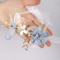 Elegant bridal wrist flower with light blue fabric blooms and delicate pearls - Blue French Elegant Wrist Corsage