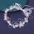 Detailed macro view of handmade bridal hairband with pearls, gold leaves and organza ribbon - Blue Headband