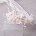 Detailed shot of bridal headband with pearls, frosted petals, and gold wire ribbon - Gold Handle