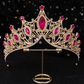 Regal golden bridal crown with fuchsia gems and sparkling crystals on a metal stand - Gold Base Rose Red Rhinestone