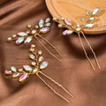 Three-piece gold bridal hair pins with marquise rhinestones on a brown silk background - Colorful Zirconia