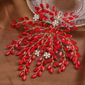 Detailed close-up of handmade bridal headband with red rhinestones and gold wire branches - Red