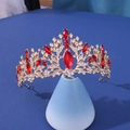 Elegant gold bridal crown with red gemstones and white rhinestones on blue stand - Symmetrical Vine Red Marquise Rhinestone Style (303)