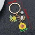 Cute yellow bee and sunflower keychain with honey pot charm and white pearl detail - Sunflower Pearl Bee Honey Jar (ER1737)