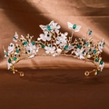 Golden bridal tiara with emerald rhinestones, white flowers, and metal butterflies - Green