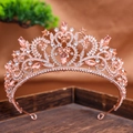 Detail of rose gold bridal crown with heart patterns, white rhinestones and champagne crystals - Champagne
