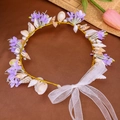 Detail of seashell headband with purple flowers, pearls, and a white organza bow tie - Purple 2
