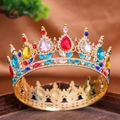 Detailed macro view of vintage golden crown with colorful gemstones and hollow patterns - All Rainbow