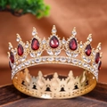 Detail showing red teardrop gemstones and white rhinestones on a gold wedding crown - Fuschia