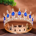Exquisite golden crown featuring deep blue teardrop gemstones and sparkling rhinestones - Sapphire Blue