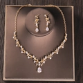 Elegant gold bridal jewelry set with sparkling floral crystals and teardrop pendants - Gold