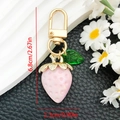 Detail view of strawberry keychain dimensions 6.8cm height with pink resin and gold clip - Solid Pink Strawberry (ER940)