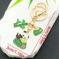 Cartoon panda keychain with bamboo and zongzi charm in gold finish alloy material - Panda Zongzi Bamboo Style (ER1554)