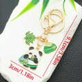 Cartoon panda keychain with zongzi and leaf pendants, gold enamel finish, size 9.1cm x 3cm - Panda Zongzi Mugwort Style (ER1555)