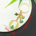 Cartoon Dragon Boat Festival zongzi keychain in gold metal finish with green enamel details - Cartoon Smiley Zongzi (ER1573)