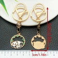 Chinese panda keychain with gold finish and enamel details on white ceramic plate - Mother and Baby Panda (ER1060)