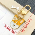 Cartoon corgi enamel keychain featuring orange dog head and silver bone charm - Yellow And White Dog Head With Flower Style (LS363)