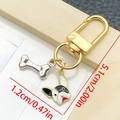 Cartoon bulldog keychain with golden D-ring and silver bone charm on cream background - Black And White Dog Head Style (LS365)
