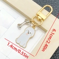 Portachiavi con cucciolo e osso cartoon con dimensioni 6,1cm di altezza e finitura oro - Cane Sorridente Bianco (LS349)