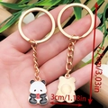 Simpatico portachiavi a forma di panda in metallo dorato e smalto, 7,7x3 cm - Stile Panda con Mela (ER1044)