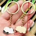 Cute panda metal keychain in gold finish, featuring enamel black and white panda charm - Drip Oil White Chinese Style Lying Right Panda Style (ER1039)