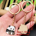 Cute panda bamboo keychain in golden alloy with enamel details and size markings - Panda Holding Bamboo Shoot Style (ER1029)