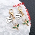 Detailed view of white tulip charm with lobster clasp and Thank You heart pendant - White Tulip (ER2082)