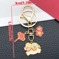 Cartoon zodiac horse keychain with red lucky knot and gold coin charms in white color - Chinese Knot Flower Reunion Horse