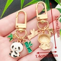 Cute panda and bamboo metal keychain with gold plating and enamel charms for bags - Waving Panda (ER1121)