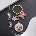 Pink butterfly and flower alloy keychain with golden finish and drip oil enamel charms - Butterfly And Flower Style (ER692) / Pink