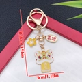Gouden Chinese leeuw sleutelhanger met Na Fu zegenvlag en geluksamuletten - Emaille Geel Zegen Leeuw Sakura (ER2145)