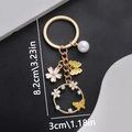 Eleganter goldener Schlüsselanhänger mit gelben Emaille-Schmetterlingen und Perle - Tropföl Gelb Schmetterling Blume Schlüsselanhänger (ER698)