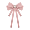 Detailed macro view of pink velvet bow brooch with center pearl and sparkling rhinestones - Pink