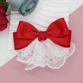 Detaillierte Nahaufnahme einer roten Satin-Haarschleife mit weißer Spitze und Nähten - Rot