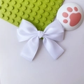 Close-up of elegant white satin bow hair clip with double-layered ribbons and glossy finish - White