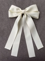 Elegant cream-colored satin double bow hair clip with long silk ribbons and glossy finish - Off White