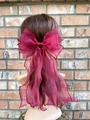 Detailed view of layered dark red organza bow hair clip with wavy ribbon streamers - Burgundy