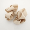 Detailed macro view of the layered beige grosgrain ribbon texture on the bow hair clip - Khaki