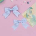 Détail de pinces à cheveux nœuds bleu clair sur un fond décoratif rose pastel doux - Ensemble de 2 Pièces / Bleu