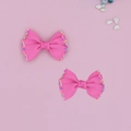 Dettaglio di fiocchi rosa in nastro grosgrain per bambini con bordi di paillettes colorate - Rosa scuro