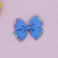 Close-up of blue grosgrain ribbon hair bow with colorful candy sprinkles on edges - Sapphire Blue
