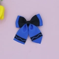 Close-up of grosgrain ribbon bow hair clip with blue and black wavy pattern design - Sapphire Blue