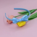 Detailed close-up of sky blue ribbed grosgrain bow headband on pink background - Blue Gold